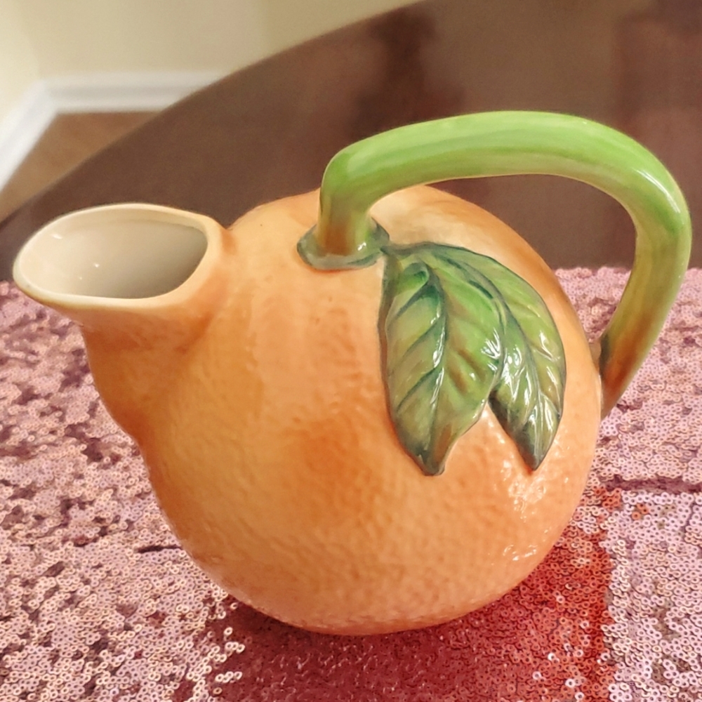 Orange ceramic pitcher